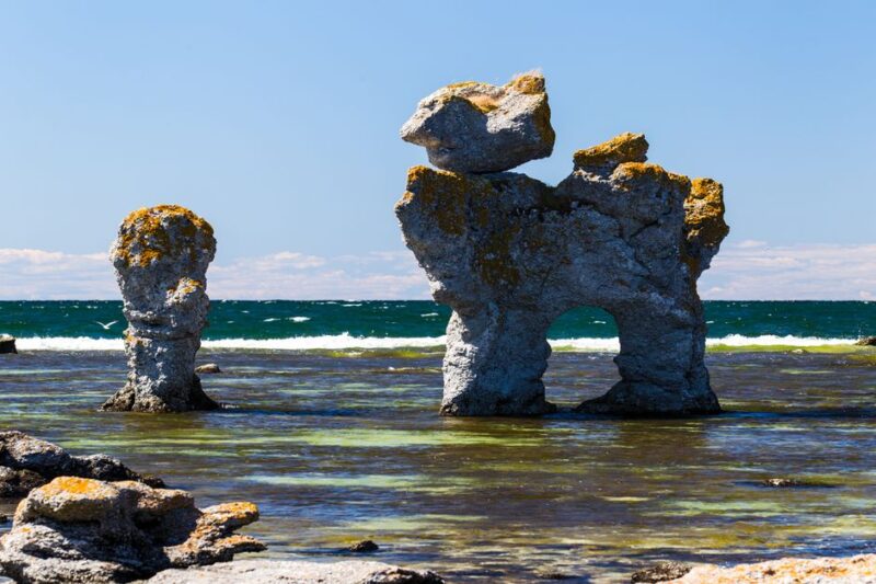 Explore the unique sea stacks of Gotland, Sweden, on a sunny summer day by the beach.